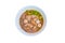 Noodle meat ball and pig piece in bowl on table with broth intense. top view isolated over white background and clipping path