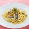 Noodle pasta with sardine fish on white platter