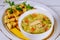 Noodle soup with chicken, parsley and croutons