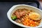 Noodle with spicy sauce, sliced chicken, fried egg, broccoli, corn and carrot, instant food, delicatessen, frozen food