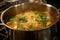 noodles being added to simmering soup