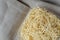 Noodles in plastic container on linen background with copy space