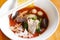 Noodles with seafood on red soup - hot and spicy thai food noodle squid pork fish ball morning glory crispy wonton skin pork and