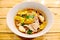 Noodles in thai spicy tom yum soup with pork and pork balls