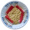 Noodles in a tiled bowl with crab sticks on a white background