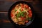 Noodles with vegetables in a black bowl on a wooden background, Chinese noodle soup with vegetables on black wooden background,