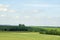 Noon in June. Expanses. Space. Beautiful view of the fields and coppice on a sunny day