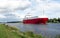 Nord-Ostsee-Kanal with red cargo ship near Rendsburg, Germany