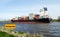 Nord-Ostsee-Kanal with sign and container ship near Rendsburg, Germany