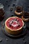 Nordic berry dessert. Open lingonberry pie with raw raspberries and currants with black coffee on black background