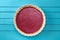 Nordic dessert. Simple homemade lingonberry cowberry pie on blue