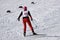 Nordic skier in red in white winter nature full of snow. Sport active photo