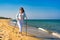 Nordic walking - beautiful woman exercising on beach