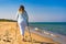 Nordic walking - beautiful woman exercising on beach