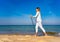 Nordic walking - beautiful woman exercising on beach