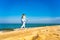 Nordic walking - beautiful woman exercising on beach