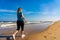 Nordic walking - beautiful woman exercising on beach