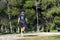 Nordic walking. Young person practicing the sport Nordic walking with poles in an outdoor park in Madrid, in Spain.