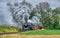 Norfolk and Western Steam Locomotive no. 611 Freight Train Blowing Smoke and Steam as it Travel Through Countryside