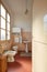 Normal bathroom with pink tiles in old apartment interior