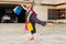 Normal woman jumping with happiness and joy with colorful bags in her hands while going shopping. lifestyle and sales discount