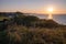 Normandy coast sunset view of cliffs water and grassy hill in France.