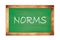 NORMS text written on green school board