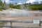 NORRIS JUNCTION, WYOMING - JUNE 7, 2017: Echinus Geyser in the Back Basin Area of Norris Geyser Basin in Yellowstone National Park