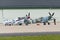 North American P-51 Mustang and Supermarine Spitfire airborne near the hangar