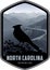 North Carolina vector label with Red Male Northern Cardinal near Blue Ridge Parkway