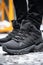 The north face men& x27;s black mid-height hiking boots. Generative AI image.