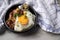 North German Hamburg Labskaus is a delicacy with corned beef, potatoes, beetroot, pickled gherkins, fried egg and herring in bowl