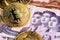North Korea currency banknotes with Bitcoin BTC cryptocurrency coins.