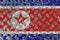 North Korea flag with over steel diamond metal plate.