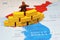 North Korean figurine peering South Korea on map, conflict between Capitalism and Communism