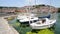North macedonia. Ohrid. Different sail boats beside dock on lake and houses on hill on background