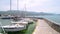 North macedonia. Ohrid. Different sail boats beside dock on ohrid lake with mountaines on background