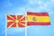 North Macedonia and Spain two flags on flagpoles and blue sky