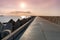 North pier with breakwaters, sunset seascape, Tetrapods along edges of pier, Beautiful evening seascape, Modern lighthouse in