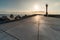 North pier with breakwaters, sunset seascape. Tetrapods along edges of pier. Beautiful evening seascape. Modern lighthouse in