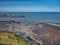 North of Robin Hood`s Bay in Yorkshire, UK, low tide reveals the plateau of the Cleveland Ironstone Formation