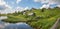 North Russian village. Summer day, river, old cottages on coast.