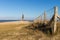 North Sea Germany, Kugelbake, old sea sign and landmark symbol of Cuxhaven with fence