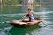 North Vietnamese girl rows boat across lake