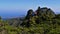 Northeastern coast of Madeira, Portugal with green forest, mountains and restaurant for hikers near Pico Ruivo (1,862m).