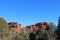 The Northern Boynton Canyon Spire and mesas behind Cypress and evergreen trees in Sedona, Arizona