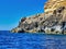 Northern coast grottos and rocks seen by boat. View from the sea. We can see them. Cretan wild coastline and countryside. Blue sea