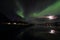 Northern Light mirroring in a Lofoten\'s fjord