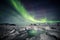 Northern Lights above the Arctic glacier and mountains - Svalbard, Spitsbergen