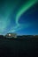 Northern Lights above Icelandic landscape with caravan